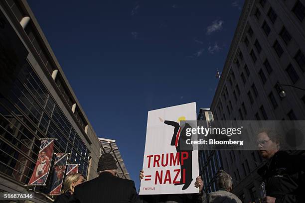 Protester holds a sign outside the American Israeli Public Affairs Committee policy conference in Washington, D.C., U.S., on Monday, March 21, 2016....