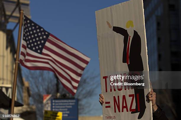 Protester holds a sign outside the American Israeli Public Affairs Committee policy conference in Washington, D.C., U.S., on Monday, March 21, 2016....