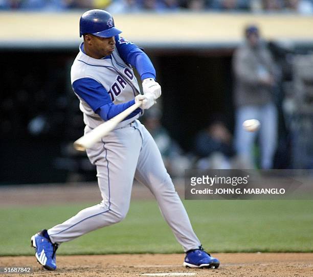 Toronto Blue Jays' Vernon Wells follows through with a two-run RBI single against the Oakland Athletics' pitcher Mark Mulder in the second inning 10...
