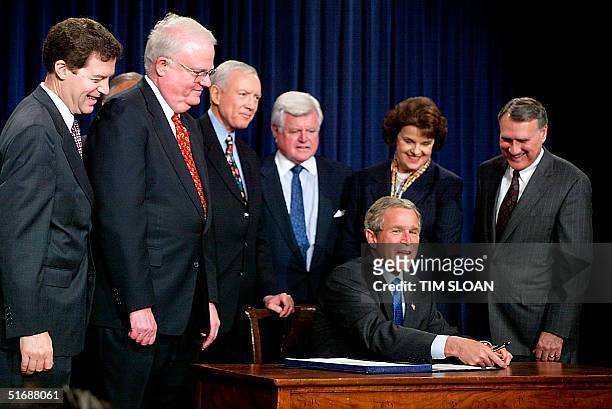 President George W. Bush signs the Enhanced Border Security and Visa Entry Reform Act into law joined by Senator Sam Brownback , Rep. James...