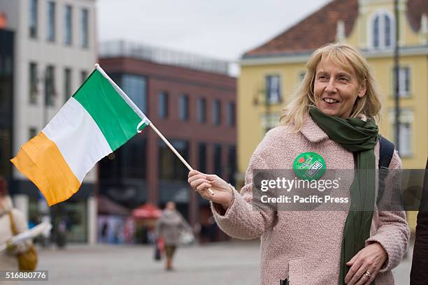 Citizen joins in the celebration of Saint Patricks day on the old market square, the first of such celebrations organized in Polish history.