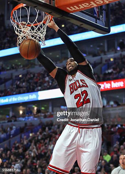 Taj Gibson of the Chicago Bulls dunks against the Sacramento Kings at the United Center on March 21, 2016 in Chicago, Illinois. The Bulls defeated...