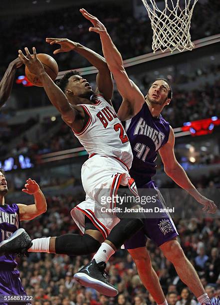 Jimmy Butler of the Chicago Bulls is fouled while shooting by Kosta Koufos of the Sacramento Kings at the United Center on March 21, 2016 in Chicago,...