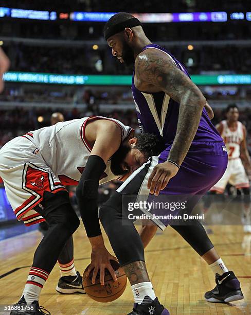 Nikola Mirotic of the Chicago Bulls tries to move against DeMarcus Cousins of the Sacramento Kings at the United Center on March 21, 2016 in Chicago,...