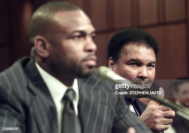 Boxing legend Muhammad Ali gives a thumbs up to Roy Jones, Jr. , a professional boxer, as he testifies before the Senate subcommittee on Consumer...