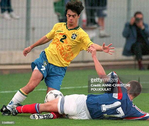 Brazilian defender Bruno Segadas Vianna tries to avoid a tackle of French FrTdTric Dindeleux 14 June during the final of the Toulon Under-21 trophy...