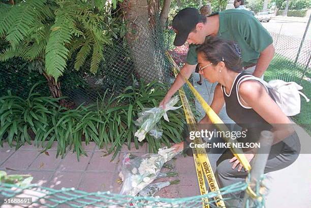 An unidentified man and woman place flowers on the walkway of Nicole Brown Simpson's condominium in Brentwood, California, 12 June. Simpson and her...