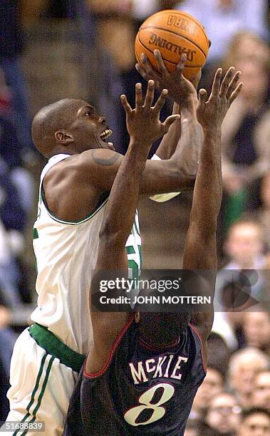 Aaron McKie of the Philadelphia 76ers attempts a block on Eric Williams of the Boston Celtics in the second game of their first round NBA Eastern...