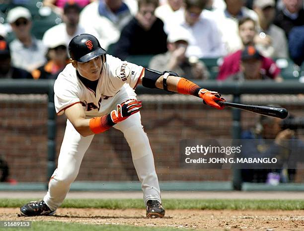 San Francisco Giants' Tsuyoshi Shinjo slaps the ball back to Philadelphia Phillies' pitcher Terry Adams 01 May 2002 in San Francisco. Adams kicked...