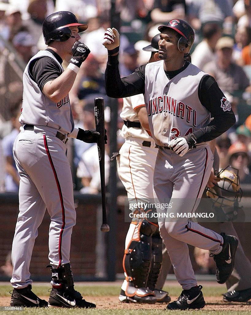 Greeted Cincinnati Reds' Juan Encarnacion is greeted by teammate Sean Casey ...
