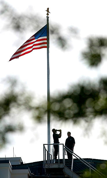 Secret Service Counter Snipers look out over the West Wing during the dedication ceremony to rename the the Old Executive Office Building next door...