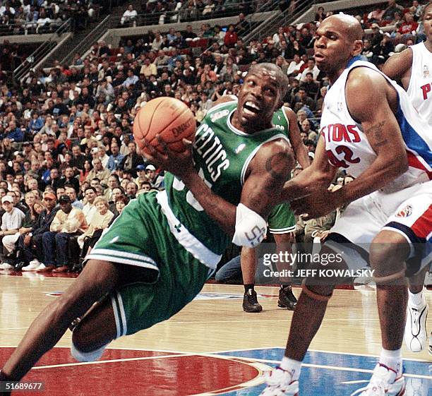 Boston Celtics' Eric Williams falls while driving around Detroit Pistons' Jerry Stackhouse during the first quarter of the second game of their...