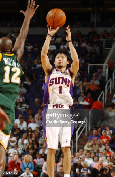 Yuta Tabuse of the Phoenix Suns shoots on Damien Wilkins of the Seattle Sonics during the preseason game at America West Arena on October 26, 2004 in...