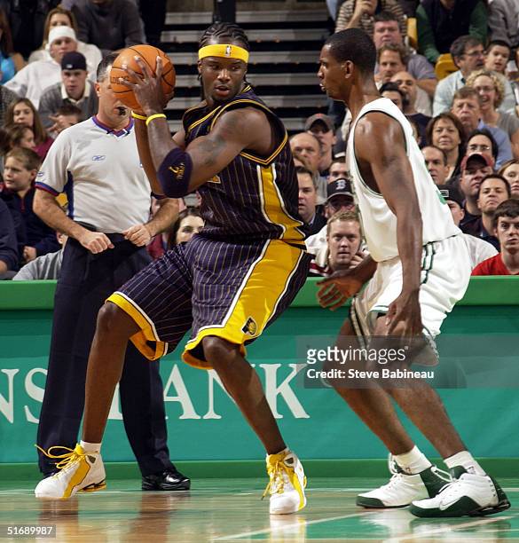 Jermaine O'Neal of the Indiana Pacers against Mark Blount of the Boston Celtics in NBA action at FleetCenter November 5, 2004 in Boston,...