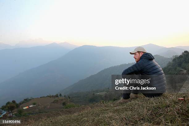 Prince Harry watches the sun rise after spending the night in the Himalayan hilltop village of Leorani on day four of his visit to Nepal on March 22,...