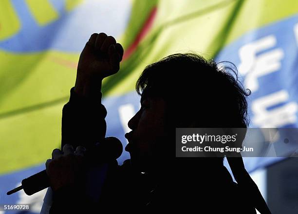 South Korean protester from a public service labor union shouts anti-government slogans during a rally in front of the National Assembly, on November...