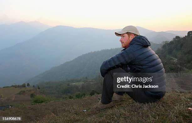 Prince Harry watches the sun rise after spending the night in the Himalayan hilltop village of Leorani on day four of his visit to Nepal on March 22,...