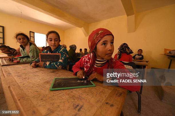 Children sit in a classroom at a school in the Moroccan village of Taghzirt, in el-Haouz province in the High Atlas Mountains south of the capital of...