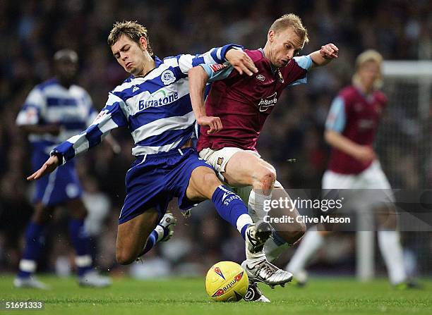 Luke Chadwick of West Ham United is tackled by Lee Cook of Queens Park Rangers during the Coca Cola Championship match between West Ham United and...