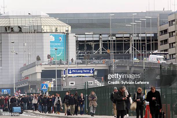 Passengers are evacuated from Zaventem Bruxelles International Airport after a terrorist attack on March 22, 2016 in Brussels, Belgium. At least 13...
