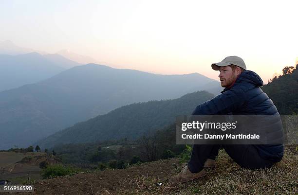 Prince Harry watches the sun rise after spending the night in the Himalayan hilltop village of Leorani on day four of his visit to Nepal on March 22,...