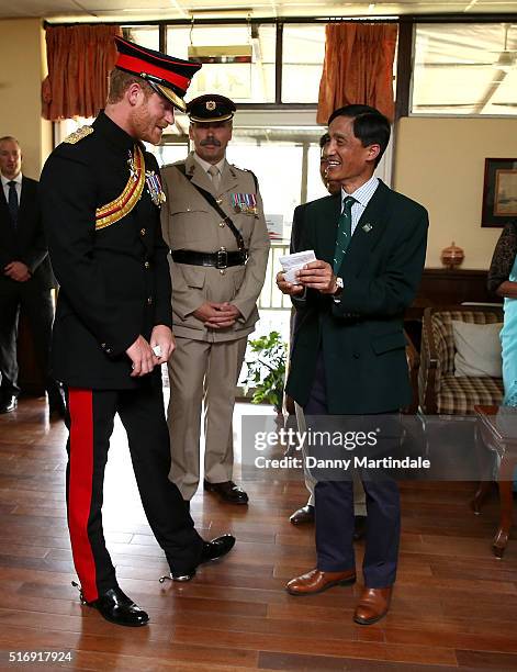 Prince Harry meets Bishnukunr Pun a Gurkha who he took him around Salisbury Plain when he was 6 years old with his father shows him a picture of the...