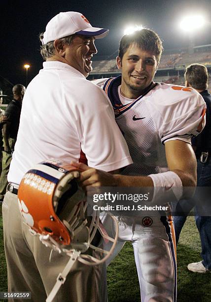 Quarterback Charlie Whitehurst of the Clemson Tigers gets a hug from Assistant Head Coach Brad Scott after defeating the University of Miami 24-17 on...