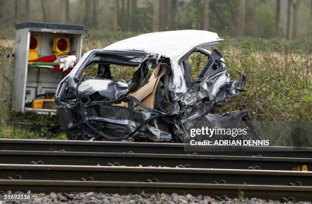 The remains of a car lies beside the track the morning after a high-speed train hit the car on a crossing in the village of Ufton Nevet near Reading,...