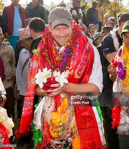 Prince Harry is given garlands and flowers as he visits Gauda Secondary School, an earthquake-damaged school being reconstructed with assistance from...