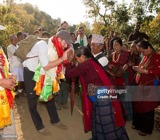 Prince Harry is given garlands and flowers as he visits Gauda Secondary School, an earthquake-damaged school being reconstructed with assistance from...