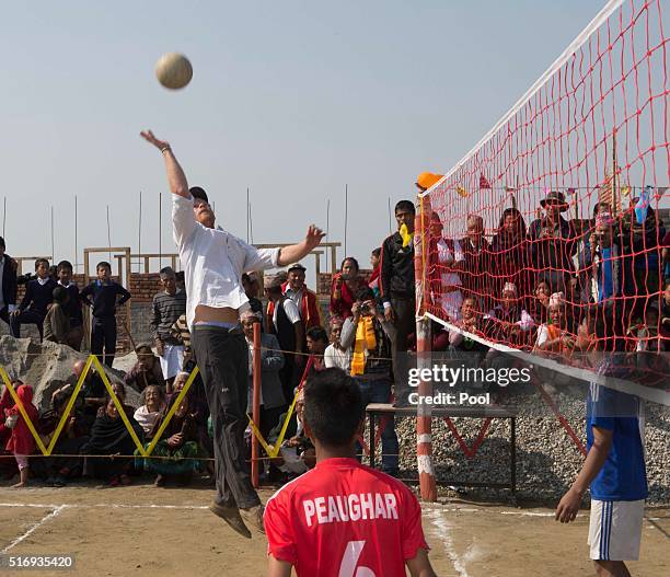 Prince Harry plays volleyball with local school children as he visits Gauda Secondary School, an earthquake-damaged school being reconstructed with...