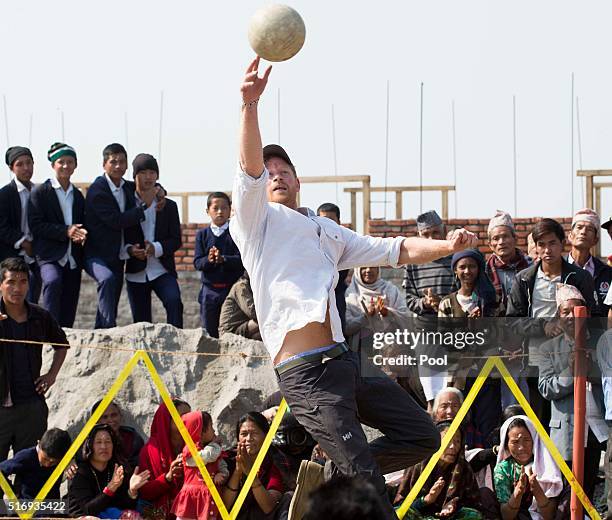 Prince Harry plays volleyball with local school children as he visits Gauda Secondary School, an earthquake-damaged school being reconstructed with...