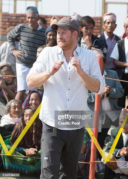 Prince Harry plays volleyball with local school children as he visits Gauda Secondary School, an earthquake-damaged school being reconstructed with...