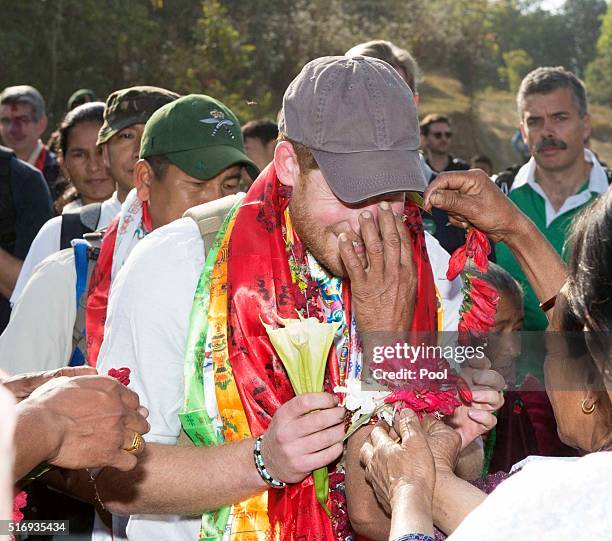 Prince Harry is given garlands and flowers as he visits Gauda Secondary School, an earthquake-damaged school being reconstructed with assistance from...