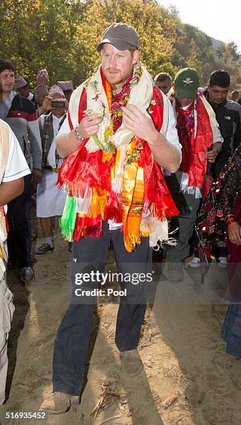 Prince Harry is given garlands and flowers as he visits Gauda Secondary School, an earthquake-damaged school being reconstructed with assistance from...