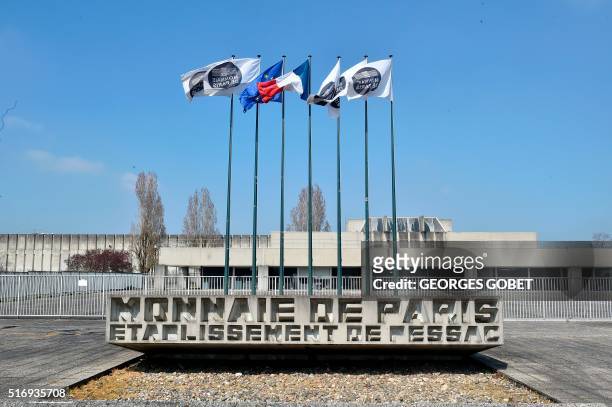 Photo shows flags at the entrance of the Monnaie de Paris in Pessac, western France, on March 21, 2016. - The Monnaie de Paris will create two series...