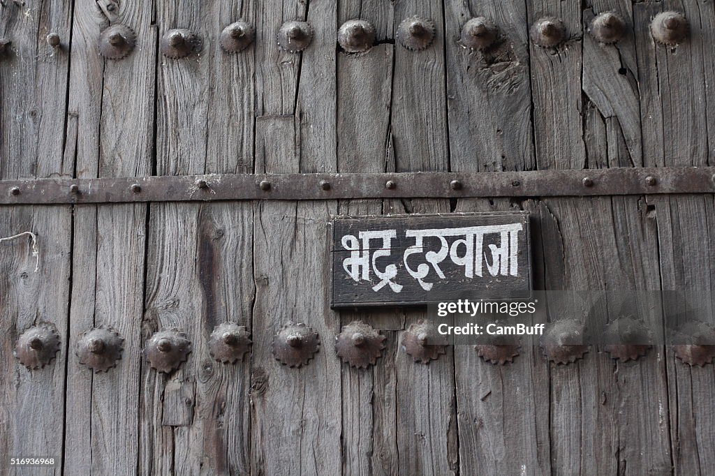Wooden door with sign board from old era, Indo - Persian style architecture from Ahmedabad old city, Gujarat.