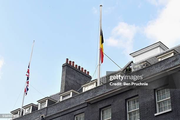 The Belgian national flag is raised as a mark of respect at Downing Street on March 22, 2016 in London, England. At least 34 people are thought to...