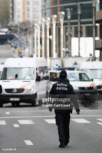 Police officer patrols outside Maelbeek metro station following todays attack on March 22, 2016 in Brussels, Belgium. At least 31 people are thought...