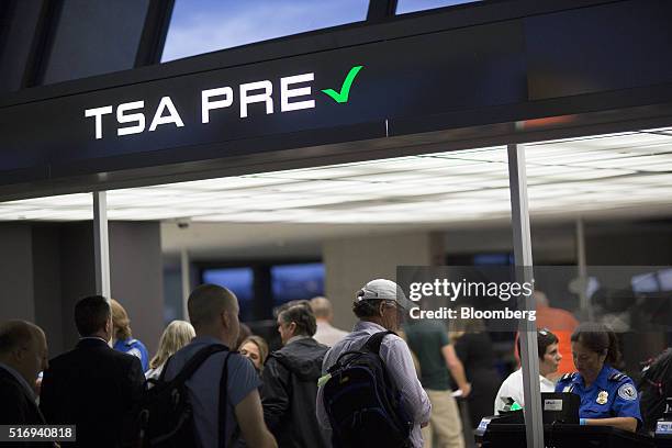 Passengers stand in the Transportation Security Administration pre-check line at Dulles International Airport in Dulles, Virginia, U.S., on...