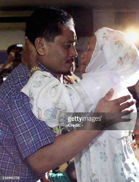 Abdul Jawah Salawat a hostage released by Abu Sayyaf rebels in the southern Philippines hugs his mother Asburah Pauddin after they were reunited at a...