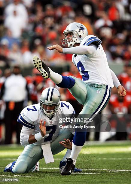 Billy Cundiff of the Dallas Cowboys kicks a field goal as teammate Drew Henson holds against the Cincinnati Bengals at Paul Brown Stadium November 7,...