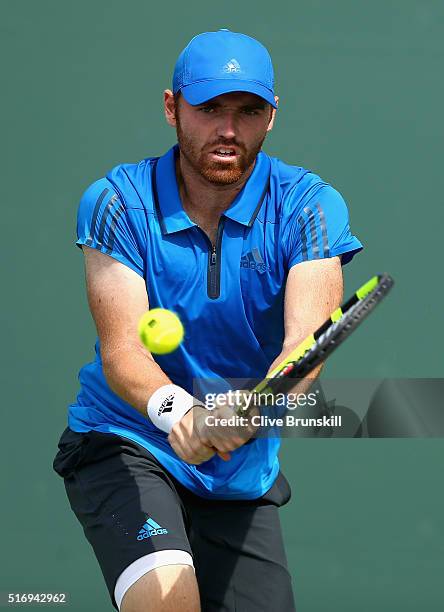 Bjorn Fratangelo of the United States plays a backhand during his straight sets victory in his final qualifying round match against James Ward of...