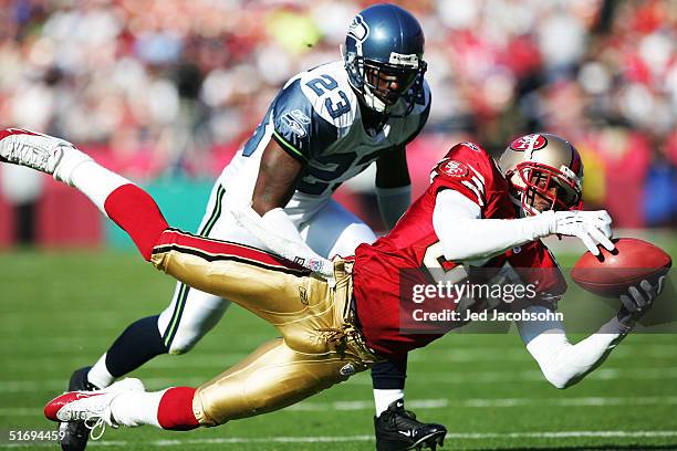 Brandon Lloyd of the San Francisco 49ers makes an incomplete pass against Marcus Trufant of the Seattle Seahawks at Monster Park on November 7, 2004...