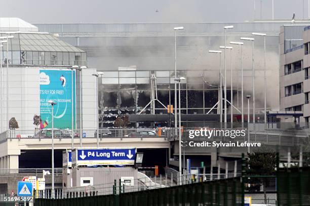 Plume of smoke rises over Brussels airport after the controlled explosion of a third device in Zaventem Bruxelles International Airport after a...