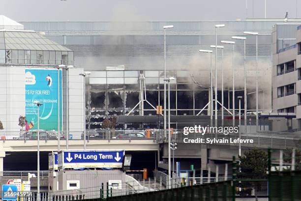 Plume of smoke rises over Brussels airport after the controlled explosion of a third device in Zaventem Bruxelles International Airport after a...