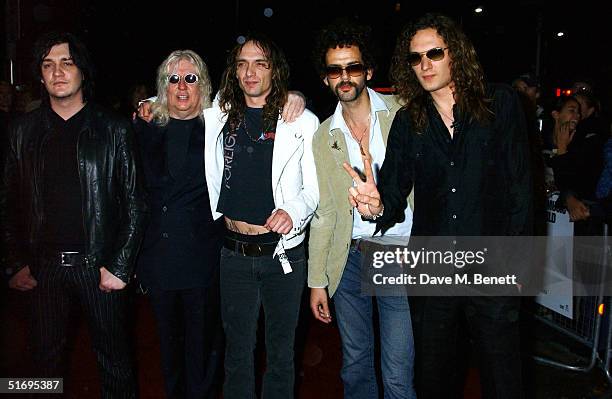 Ed Graham, guest, Justin Hawkins, Frankie Poullain and Dan Hawkins of the band The Darkeness arrive at the Premiere screening of the new four-disc...