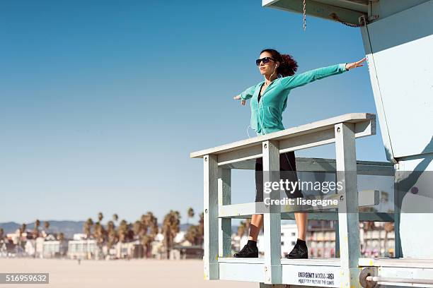 woman exercising in la, venice beach, california - venice beach stock pictures, royalty-free photos & images