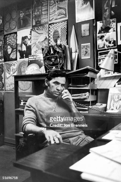 German-born American businessman Bill Graham , rock concert producer and promoter, talks on the phone in his office at the Fillmore West music club,...