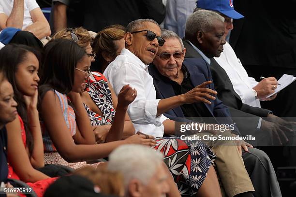 President Barack Obama and Cuban President Raul Castro visit during an exhibition game between the Cuban national team and the Major League Baseball...